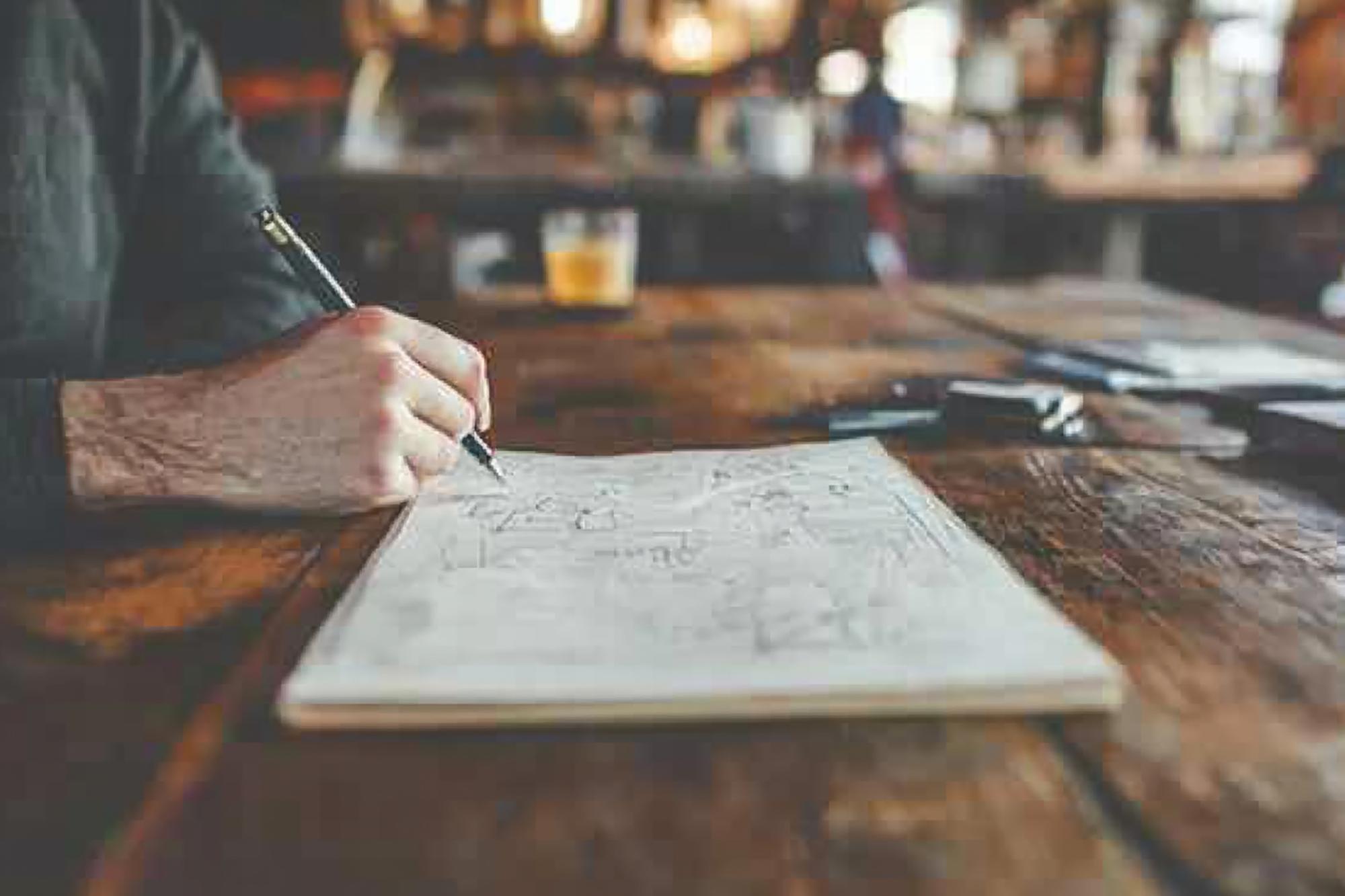 Notebook and menu sketches on a table